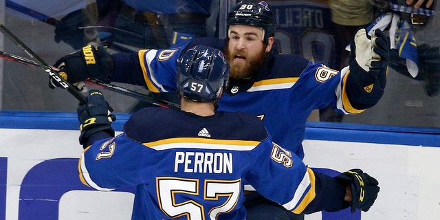 Ryan O'Reilly (90) celebrates with David Perron (57) after O. Reilly scored his second goal of the game in the third period of Game 4 of the Stanley Cup Final against the Bruins of Boston, Monday, June 3, 2019, in St. Louis. (AP Photo / Scott Kane)