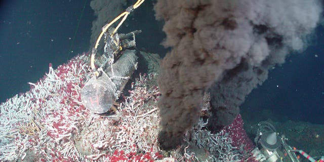Every year, billions of gallons of ocean water fall into the Earth at tectonic plate boundaries, then gush back out at hydrothermal vents like the one seen here. A new study shows that this deep water cycle may contribute to hundreds of feet of sea level loss over time.
