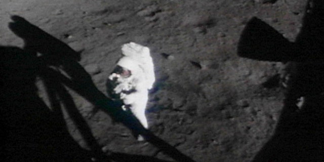 U.S. Astronaut Neil Armstrong turns towards the lunar module on the moon in this handout photo from NASA.