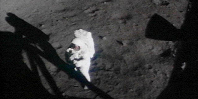 U.S. Astronaut Neil Armstrong turns towards the lunar module on the moon in this handout photo from NASA.