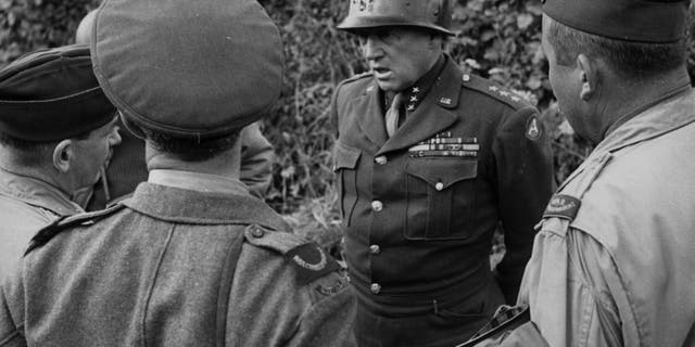 August 1944: General George S. Patton (1885-1945), head of the 3rd Army, talks to Allied war correspondents in Normandy, France.