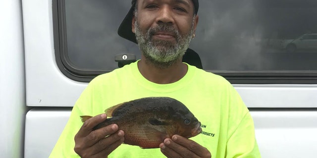 Alphonso Jackson poses with his record-breaking catch.