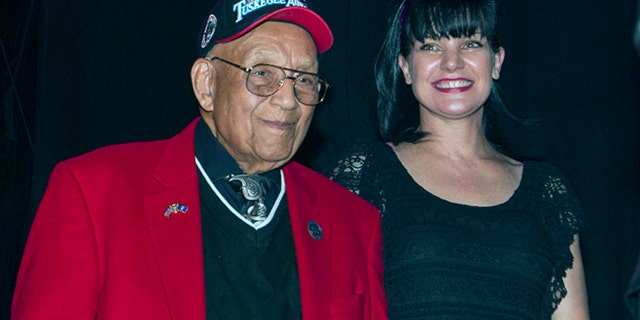 Lt. Col. Bob Friend, a Tuskegee Airman, stands onstage with actress Pauley Perrette during a benefit concert at The House of Blues in Los Angeles in 2013. (Photo by Paul A. Hebert/Invision/AP, File)