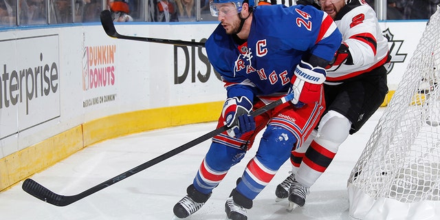 Former New York Rangers captain Ryan Callahan #24, skates the puck under pressure from Marek Zidlicky #2 of the New Jersey Devils in Game Two of the Eastern Conference Final during the 2012 NHL Stanley Cup Playoffs at Madison Square Garden on May 16, 2012 in New York City. (Photo by Scott Levy/NHLI via Getty Images)