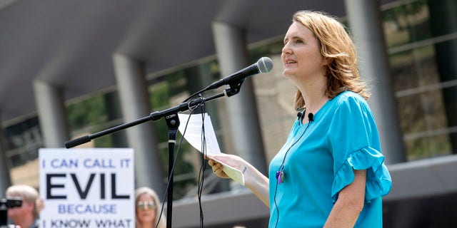 FILE - In this Tuesday, June 12, 2018 file photo, rape survivor and abuse victim advocate Mary DeMuth speaks during a rally protesting the Southern Baptist Convention's treatment of women outside the convention's annual meeting at the Kay Bailey Hutchison Convention Center in Dallas. On Tuesday, June 11, 2019, the Southern Baptist Convention gathers for its annual national meeting with one sobering topic _ sex abuse by clergy and staff _ overshadowing all others. (AP Photo/Jeffrey McWhorter)
