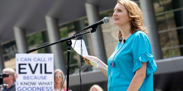 FILE - In this Tuesday, June 12, 2018 file photo, rape survivor and abuse victim advocate Mary DeMuth speaks during a rally protesting the Southern Baptist Convention's treatment of women outside the convention's annual meeting at the Kay Bailey Hutchison Convention Center in Dallas. On Tuesday, June 11, 2019, the Southern Baptist Convention gathers for its annual national meeting with one sobering topic _ sex abuse by clergy and staff _ overshadowing all others. (AP Photo/Jeffrey McWhorter)