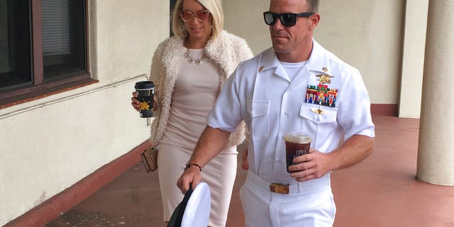 Navy Special Operations Chief Edward Gallagher, right, walks with his wife, Andrea Gallagher as they arrive to military court on Naval Base San Diego, Monday, June 24, 2019, in San Diego. (AP Photo/Julie Watson)