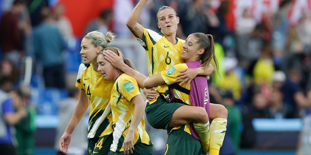 Australia's Chloe Logarzo, top, celebrates with a teammate at the end of the Women's World Cup Group C soccer match between Australia and Brazil at Stade de la Mosson in Montpellier, France, Thursday, June 13, 2019. Australia defeated Brazil 3-2. (AP Photo/Claude Paris)