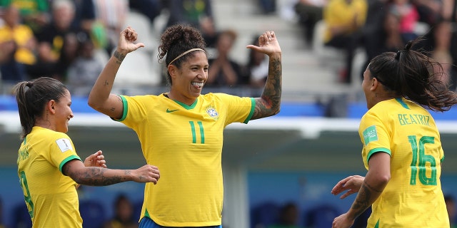 Brazil's Cristiane, center, celebrates after scoring her side's opening goal during the Women's World Cup Group C soccer match between Brazil and Jamaica in Grenoble, France, Sunday, June 9, 2019. (AP Photo/Laurent Cipriani)