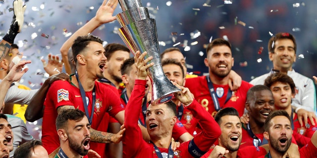 Portugal players celebrate with their trophy after defeating the Netherlands 1-0 in the UEFA Nations League final soccer match at the Dragao stadium in Porto, Portugal, Sunday, June 9, 2019. (AP Photo/Armando Franca)
