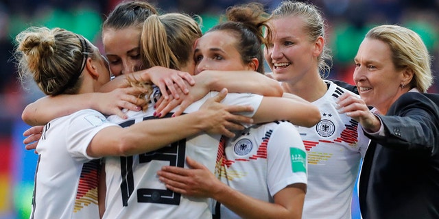 Germany head coach Martina Voss-Tecklenburg, right, celebrates with her players at the end of the Women's World Cup Group B soccer match between Spain and Germany at Stade du Hainau in Valenciennes, France, Wednesday, June 12, 2019. Germany won 1-0. (AP Photo/Michel Spingler)