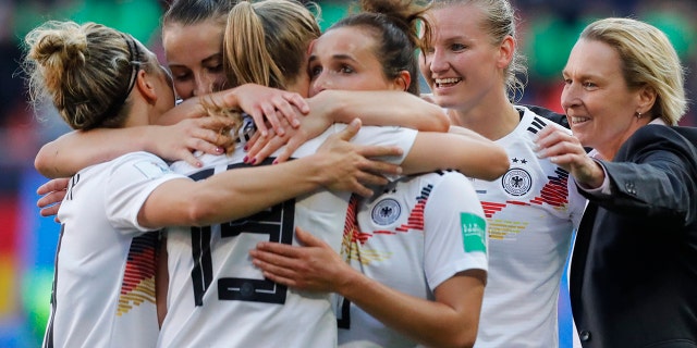 Germany head coach Martina Voss-Tecklenburg, right, celebrates with her players at the end of the Women's World Cup Group B soccer match between Spain and Germany at Stade du Hainau in Valenciennes, France, Wednesday, June 12, 2019. Germany won 1-0. (AP Photo/Michel Spingler)