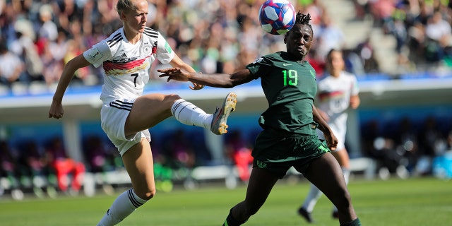 Germany's Lea Schueller, left, tussles for the ball with Nigeria's Chinwendu Ihezuo during the Women's World Cup round of 16 soccer match between Germany and Nigeria at Stade del Alpes in Grenoble, France, Saturday, June 22, 2019. Schueller scored once in Germany's 3-0 victory. (AP Photo/Laurent Cipriani)