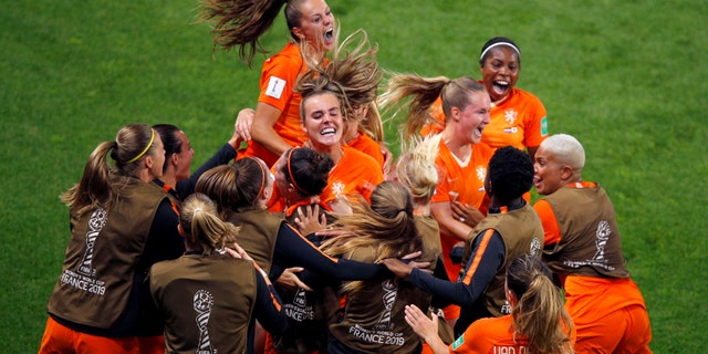 Netherlands' Lieke Martens, top, celebrates with teammates after scoring her team's second goal from the penalty spot during the Women's World Cup round of 16 soccer match between the Netherlands and Japan at Roazhon Park, in Rennes, France, Tuesday, June 25, 2019. (AP Photo/Francois Mori)