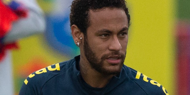 Brazil's soccer player Neymar attends a team practice session lead by national team coach Tite, behind, at the Granja Comary training center ahead the Copa America tournament in Teresopolis, Brazil, Sunday, June 2, 2019. (AP Photo/Leo Correa)