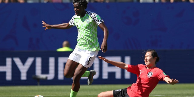 Nigeria's Asisat Oshoala gets away from South Korea's Hwang Bo-ram on her way to scoring her side's second goal during the Women's World Cup Group A soccer match between Nigeria and South Korea in Grenoble, France, Wednesday June 12, 2019.(AP Photo/Laurent Cipriani)
