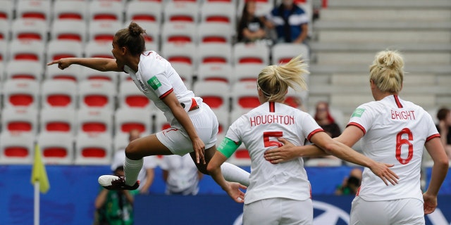 England's Nikita Parris, left, celebrates after scoring her side's opening goal on a penalty kick during the Women's World Cup Group D soccer match between England and Scotland in Nice, France, Sunday, June 9, 2019. (AP Photo/Claude Paris)