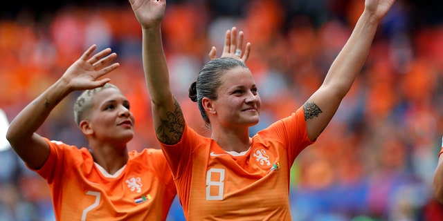 Netherlands' Shanice Van De Sanden, left, and Netherlands' Sherida Spitse, right, celebrate after the Women's World Cup Group E soccer match between the Netherlands and Cameroon at the Stade du Hainaut in Valenciennes, France, Saturday, June 15, 2019. The Netherlands defeated Cameroon by 3-1. (AP Photo/Michel Spingler)