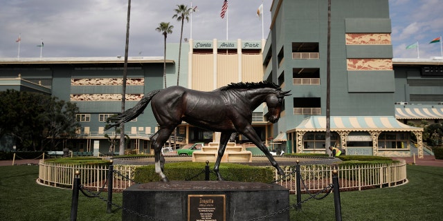 In this March 5, 2019, file photo, a statue of Zenyatta stands in the paddock gardens area at Santa Anita Park in Arcadia, Calif.