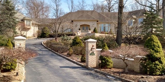 The 1.5-acre property comes with a four-bedroom house, two garages and a detached guesthouse.