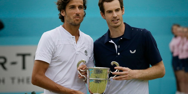Andy Murray of Britain, left, celebrates with Feliciano Lopez of Spain after winning their men's doubles final tennis match against Joe Salisbury of Britain and the Rajeev Ram of the United States at the Queens Club tennis tournament in London, Sunday June 23, 2019. (AP Photo/Tim Ireland)