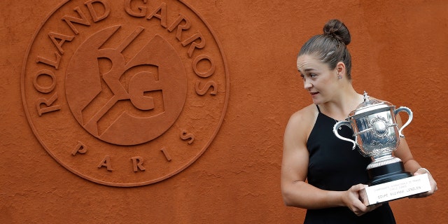 Australia's Ashleigh Barty poses with the trophy during a photo call at the Roland Garros stadium in Paris, Sunday, June 9, 2019. Barty won the French Open tennis tournament women's final on Saturday June 8, 2019. (AP Photo/Michel Euler)