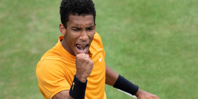 Felix Auger-Aliassime, of Canada, reacts during the quarterfinals of the Stuttgart Open tennis tournament against Dustin Brown of Germany,, Friday, June 14, 2019, in Stuttgart, Germany. Auger-Aliassime won 7-6 (3), 6-7 (2), 7-6 (2). (Silas Stein/dpa via AP)