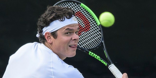 Canada's Milos Raonic returns the ball to Jo-Wilfried Tsonga of France during their match at the ATP tennis event in Stuttgart, Germanany Wednesday June 12, 2019. (Silas Stein/dpa via AP)