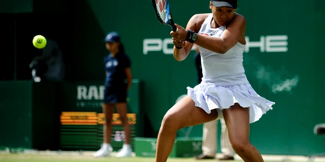Japan's Naomi Osaka returns to Kazakhstan's Yulia Putintseva during day six of the Nature Valley Classic at Edgbaston Priory Club, Birmingham, England, Thursday, June 20, 2019. (Zac Goodwin/PA via AP)