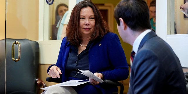 U.S. Senator Tammy Duckworth (D-IL) speaks with an aide before the announcement of the formation of the Senate Democrats' Special Committee on Climate Change on Capitol Hill in Washington, D.C., U.S., March 27, 2019. REUTERS/Joshua Roberts - RC152CDD3B80