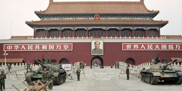 In this June 10, 1989 file photo, People's Liberation Army (PLA) troops stand guard with tanks in front of Tiananmen Square after crushing the students pro-democracy demonstrations in Beijing.