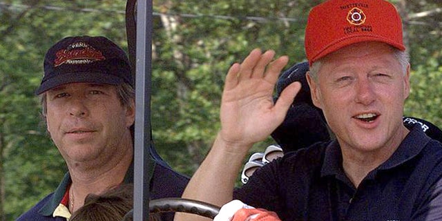 President Clinton waves to reporters as he and brother-in-law Tony Rodham, left, drive off for a round of golf at Maple Run Golf Course Saturday, Aug. 14, 1999, in Thurmont, Md. (AP Photo/Khue Bui)