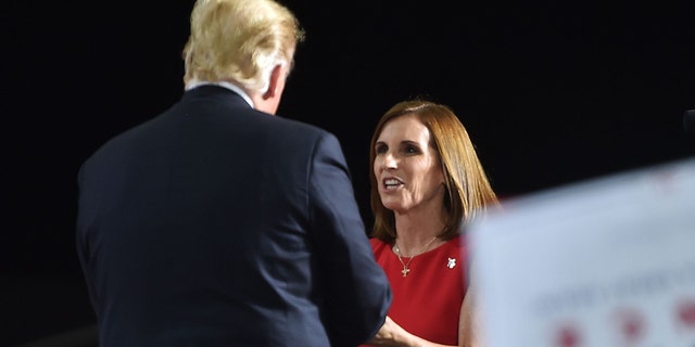 Representative Martha McSally greets US President Donald Trump during a "Make America Great" rally in Mesa, Arizona on October 19, 2018. - (NICHOLAS KAMM/AFP/Getty Images)