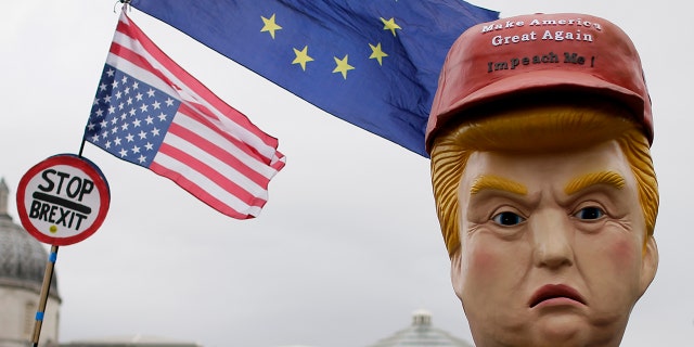 Large puppet portraying Donald Trump is carried as people gather in Trafalgar Square, central London, to demonstrate against the state visit of President Donald Trump, Tuesday. (AP Photo/Tim Ireland)