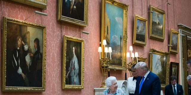 Queen Elizabeth II shows items from the Royal Gift Collection to First Lady Melania Trump and President Donald Trump at Buckingham Palace in London, Monday, June 3, 2019.