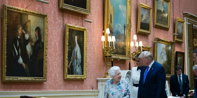 Queen Elizabeth II shows items from the Royal Gift Collection to First Lady Melania Trump and President Donald Trump at Buckingham Palace in London, Monday, June 3, 2019.