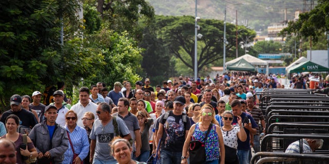 People stream across the Simon Bolivar bridge at the border between Venezuela and Colombia. The border just recently re-opened for all foot traffic. Since then approximately 30,000 people have been coming across each day.