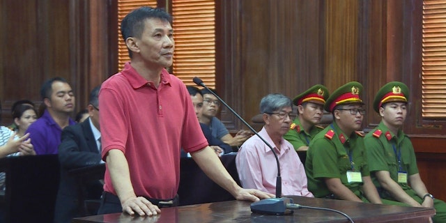 Michael Nguyen stands during his trial, Monday, June 24, 2019, in Ho Chin Minh City, Vietnam.