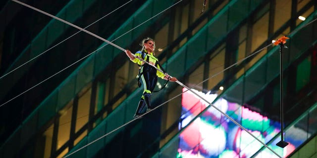 Aerialist Lijana Wallenda walks on a high wire above Times Square, Sunday, June 23, 2019, in New York. (AP Photo/Jason Szenes)