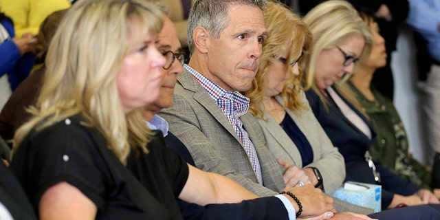 John Van Cuylenborg, center, surrounded by family and friends await the verdict of William Talbott II, Friday, June 28, 2019, at the Snohomish County Courthouse in Everett, Wash. Talbott was found guilty in the 1987 killings of Jay Cook and Tanya Van Cuylenborg, a young Canadian couple. (Kevin Clark/The Herald via AP, Pool)