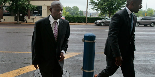 Former FBI agent William Don Tisaby, left, accompanied by attorney Jermaine Wooten, as he turned himself in at St. Louis Police headquarters on Monday.