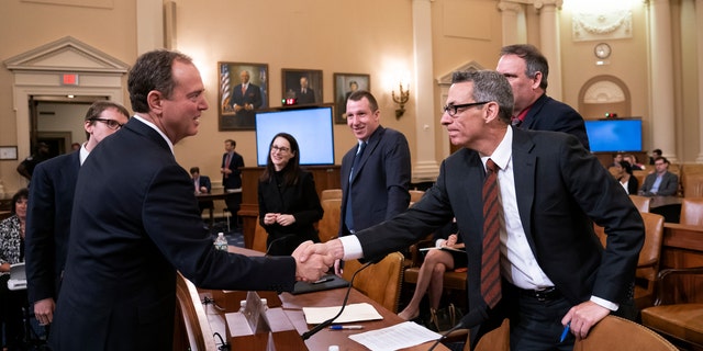 House Intelligence Committee Chairman Adam Schiff, D-Calif., left, greets witness Clint Watts, a cybersecurity and intelligence expert with the Foreign Policy Research Institute, at a hearing on Capitol Hill on Thursday. (Associated Press)