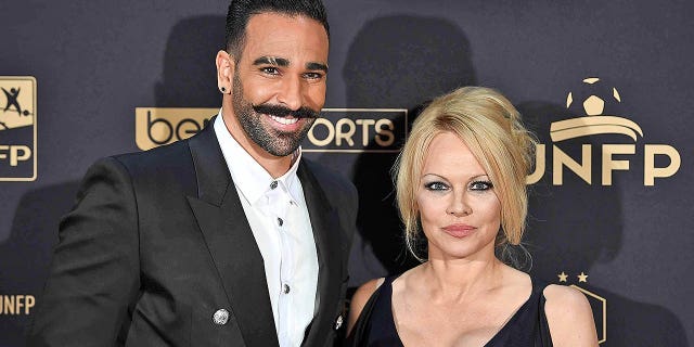 Marseille's defender Adil Rami and actress Pamela Anderson arrive to take part in a TV show on May 19, 2019 in Paris, as part of the 28th edition of the UNFP (French National Professional Football players Union) trophy ceremony. They split a month later.