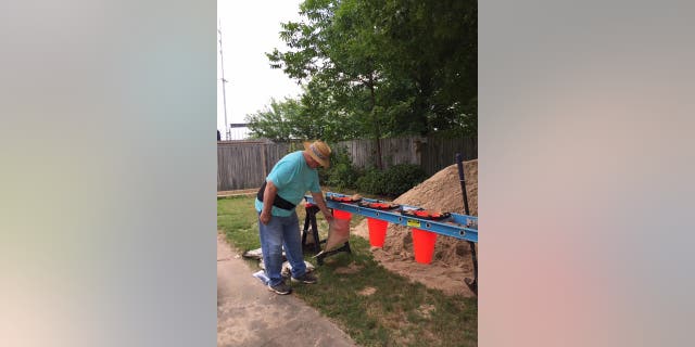 John Church filling sandbags for his Willow Beach home