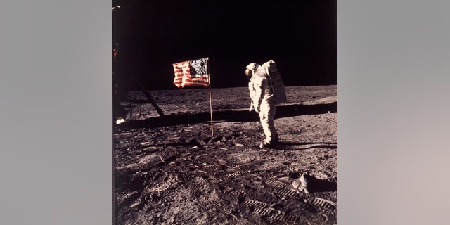 FILE - In this image provided by NASA, astronaut Buzz Aldrin poses for a photograph beside the U.S. flag deployed on the moon during the Apollo 11 mission on July 20, 1969. A new poll shows most Americans prefer focusing on potential asteroid impacts over a return to the moon. The survey by The Associated Press and the NORC Center for Public Affairs Research was released Thursday, June 20, one month before the 50th anniversary of Neil Armstrong and Aldrin’s momentous lunar landing. (Neil A. Armstrong/NASA via AP)