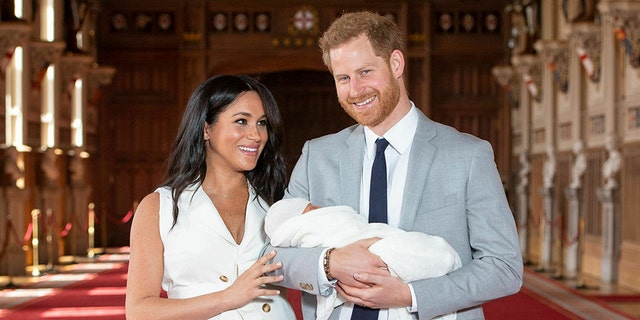 Britain's Prince Harry and Meghan, Duchess of Sussex, during a photocall with their newborn son, in St George's Hall at Windsor Castle, Windsor, south England, on May 8, 2019.  (Dominic Lipinski/Pool via AP)