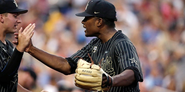 Vanderbilt pitcher Kumar Rockeer reacts at the end of the sixth inning against Michigan in Game 2 of the NCAA College World Series baseball finals in Omaha, Neb., Tuesday, June 25, 2019. (AP Photo/Nati Harnik)