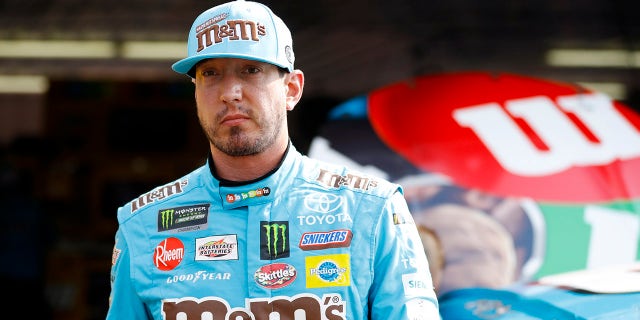 Kyle Busch walks from the garage area after a practice session for the NASCAR Cup Series race at Pocono Raceway May 31, 2019, in Long Pond, Pa.