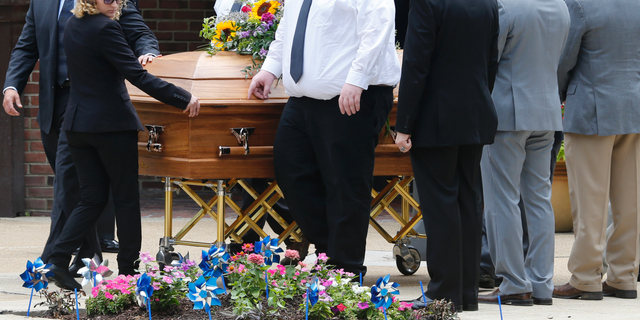 The casket of Virginia Beach shooting victim Katherine Nixon is wheeled to a hearse after a funeral service at St. Gregory The Great Catholic Church in Virginia Beach, Va Thursday, June 6, 2019. Nixon was killed along with eleven others during a mass shooting last Friday. (AP Photo/Steve Helber)