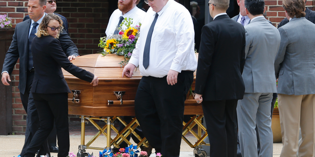 The casket of Virginia Beach shooting victim Katherine Nixon is wheeled to a hearse after a funeral service at St. Gregory The Great Catholic Church in Virginia Beach, Va Thursday, June 6, 2019. Nixon was killed along with eleven others during a mass shooting last Friday. (AP Photo/Steve Helber)